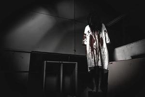 Portrait of asian woman make up ghost,Scary horror scene for background,Halloween festival concept,Ghost movies poster,angry spirit in the apartment photo