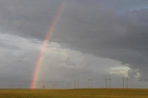 landscape with rainbow in a cloudy sky photo