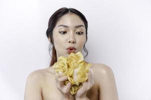 Portrait of happy Asian girl taking shower with gel. She washing with puff, body care beauty concept. photo