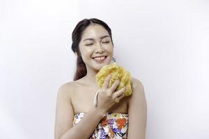 Portrait of happy Asian girl taking shower with gel. She washing with puff, body care beauty concept. photo