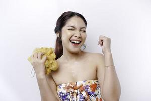 Portrait of happy Asian girl taking shower with gel. She washing with puff, body care beauty concept. photo
