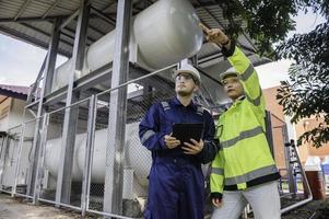 Engineers work place to keep liquid helium,preventive maintenance schedule checking,Thailand people,Technicians and engineers discuss work together. photo