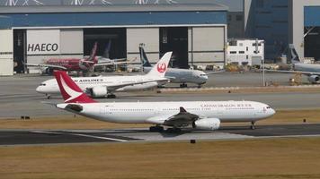 HONG KONG NOVEMBER 07, 2019 - Cathay Dragon Airbus A330, B LAB departure from Chek Lap Kok International Airport, Hong Kong HKG. Huge airliner at the start of the runway, long shot video