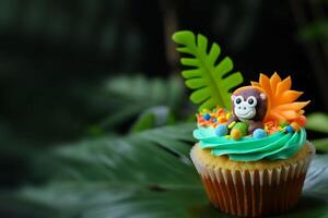 Cute cupcake for kids with copy space. Happy Birthday dessert. Children's jungle party. Empty space for text. Postcard, greeting card design. Muffin with tropical leaves and monkey. . photo