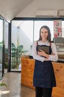 Portrait of a woman, a coffee shop business owner smiling beautifully and opening a coffee shop that is her own business, Small business concept. photo