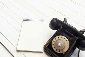 retro telephone he communication office notepad wooden background object photo