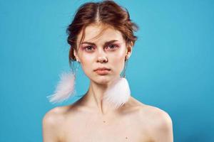 attractive woman fluffy earrings bare shoulders fashion studio photo