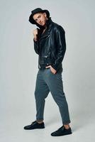 handsome man in leather jacket hat posing studio fashion photo