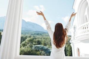 woman long hair in a white bathrobe staying on the balcony in a hotel Mountain View photo