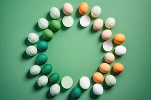 Creative Easter layout of colorful eggs on a green background, . photo