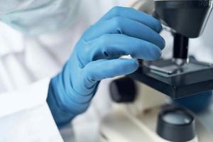 Woman in white coat microscope research diagnostics professionals photo