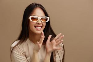 portrait woman in a beige T-shirt with glasses posing clothing fashion Green background photo