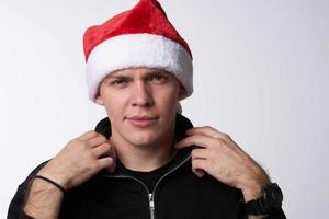 man in santa hat close-up light background holiday photo