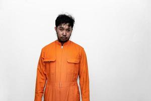 Prisoner in orange robe concept,Portrait of asian handsome man in Prison uniforms,Bandit has a lot of muscle, photo