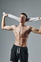 man holding towels behind his head athletic appearance workout gym photo