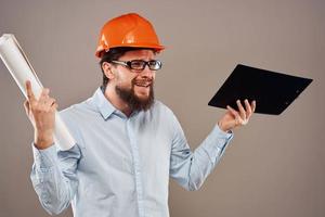 Cheerful man orange hard hat documents professional blueprints construction photo
