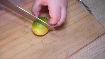 Woman cutting lime with a knife video