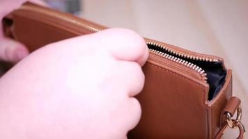 Woman opens the lock on a small bag video