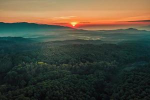 Aerial view of sunrise over mountian and pine tree in Chiang Mai Province, Thailand. photo