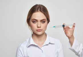 scared woman and syringe with needle near face photo