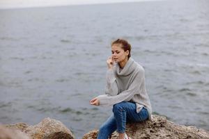 woman beach tourism cloudy weather stone coast unaltered photo