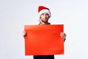 handsome man in New Year's clothes holding a banner holiday isolated background photo