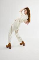 woman in suit trendy shoes bent over back light background photo