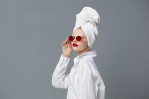 fashionable woman with a towel on his head in a white shirt isolated background photo