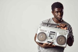 man with a tape recorder in his hands listening to music african appearance lifestyle photo