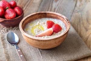 Bowl of oats with fresh strawberries photo