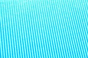 Abstract paper blue geometric symmetrical texture striped surface diagonal lines background. Structure design cardboard shape backdrop. Decoration interior concept. Flatlay, close-up photo