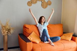 cheerful woman on the couch rest fun Comfort apartments photo