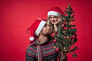 Cheerful young couple New Year in a place of Christmas holiday photo