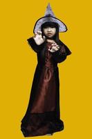 Portrait of asian little girl wear witch costume,Halloween festival concept photo