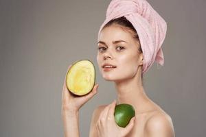 Woman with pink towel on her head cropped view of exotic fruits clean skin photo