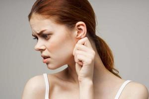 sick woman ear pain health problem dissatisfaction light background photo