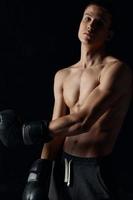 athlete in boxing gloves on black background portrait close-up photo
