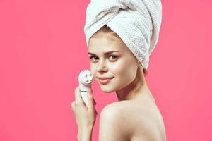woman with towel on head naked shoulders massager health dermatology photo