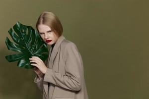 pretty woman green palm leaf coat bright makeup studio model unaltered photo
