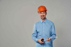 man in construction uniform blueprints builder light background photo