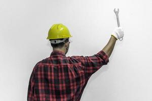 Technician wear helmet with Wrench in hand isolate on white background,Thailand people,Labor day concept photo