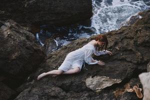 beautiful young woman in white wedding dress on sea shore wet hair Summer vacation concept photo