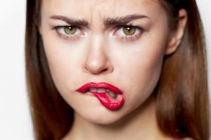 Closeup portrait of woman bites her lip charm photo