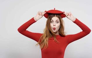 pretty woman in red hat holding hair charm fashion photo