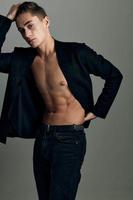 man in a black unbuttoned jacket muscular abs attractive look photo