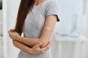 germicidal plaster on patient's shoulder and medicine hospital covid passport photo