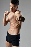 boxer on a gray background naked torso cubes on the stomach fitness photo