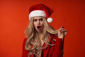 woman wearing santa hat christmas holiday red background photo