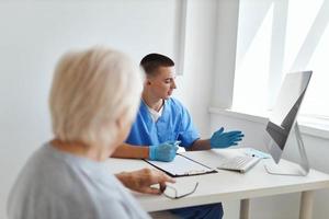 elderly woman patient talking to doctor hospital visit photo