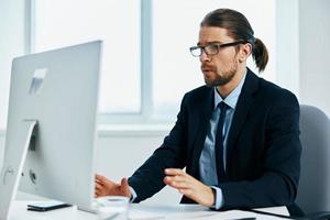 businessman sitting at a desk in front of a computer technologies photo